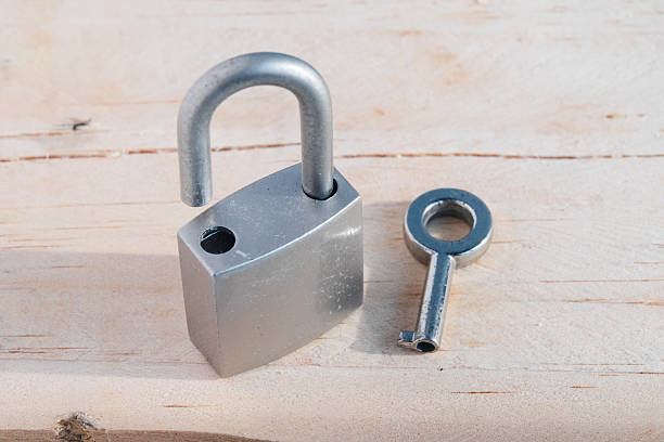 istock Key and lock on wood background 491518171