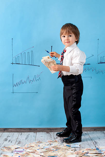 istock Little boy with a stack of money 491518521