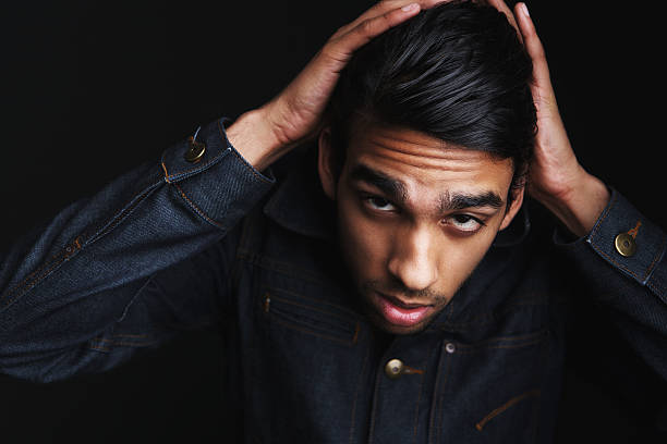 istock Man posing in denim jeans jacket with hand in hair 491521787
