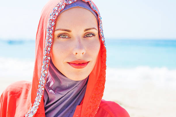 istock Women in red arabic dress on a beach 491526044