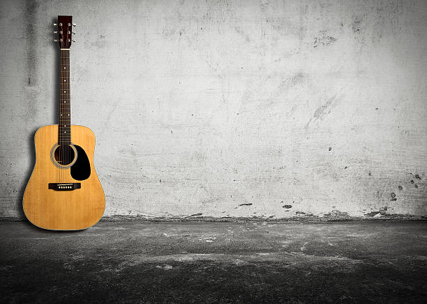 istock Acoustic guitar against old wall 491526600