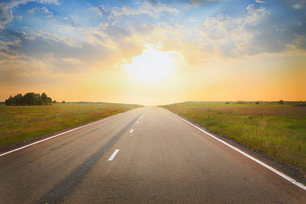 istock sunset over the country highway 491527968