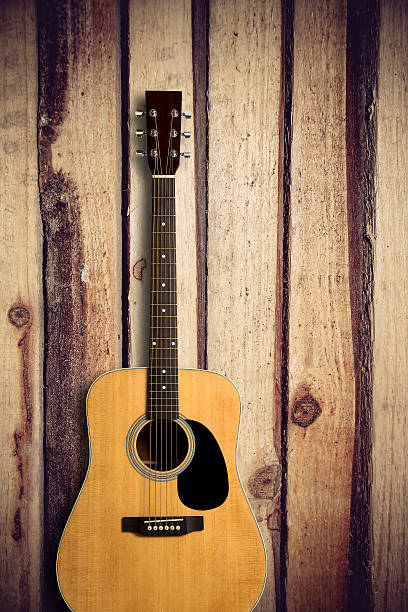 istock Acoustic guitar on wooden background 491530076