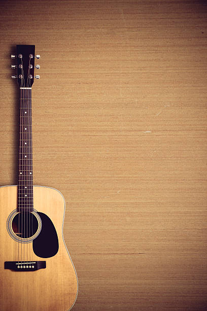 istock Acoustic guitar on wooden background 491531018
