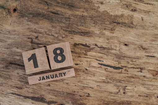 cube calendar for january on wooden surface with copy space