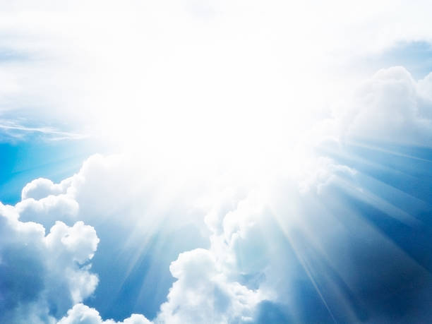 istock Dazzlingly bright sun creates radiating lens flare against clouds 491540966