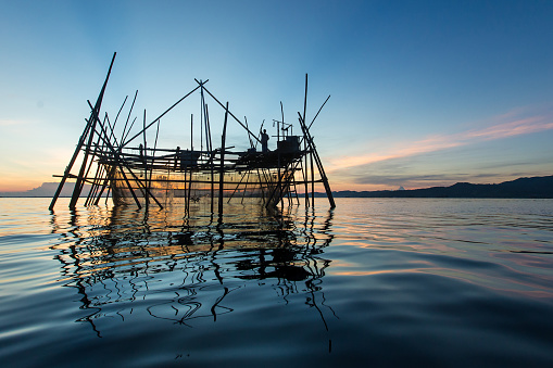 Silhouette of the traditional fishing structure built with bamboo called Bagang, typical of Sabah, Borneo.