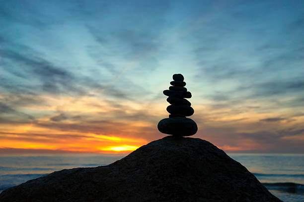 istock Cairn at sunset on the sea 491543454