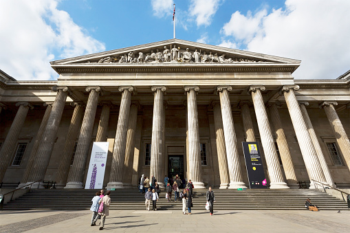 London, UK - October 10, 2012: Tourists during the day outside the main entrance of the British Museum in London. The British Museum is the most visited museum in UK and the third most visited museum in the world.