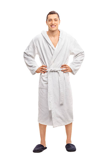 allegro giovane uomo in accappatoio bianco - bathrobe foto e immagini stock