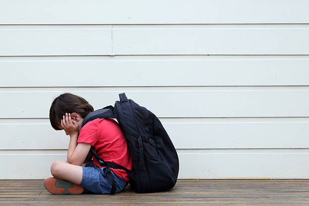 Sad Boy Young boy being bullied at school. schoolyard fight stock pictures, royalty-free photos & images