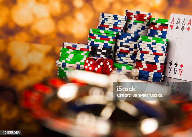 Poker Chips On A Gaming With Casino Roulette Stock Photo - Download Image Now - 2015, Activity, Addiction