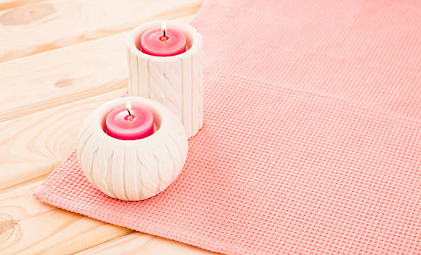 istock Beautiful candles on pink background 491559632