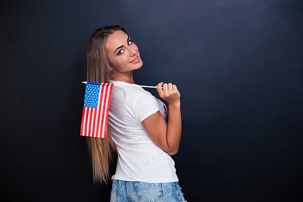 istock Smiling girl holding USA flag 491560378