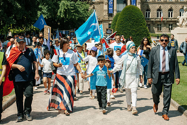 uyghur human rights activists participate in a demonstration - urumqi stockfoto's en -beelden