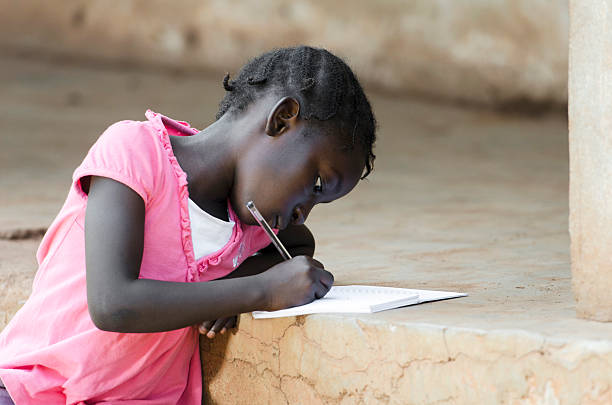 african baby mädchen schreiben (bildung für afrika hintergrund - elementary student classroom education elementary school building stock-fotos und bilder