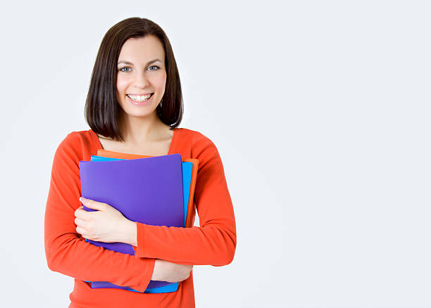 istock Young smiling student woman. Over gray background 491563248