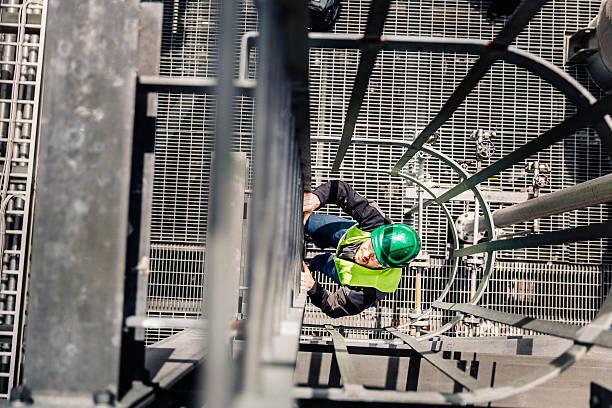 istock Young male technician climbing ladder in factory 491563748