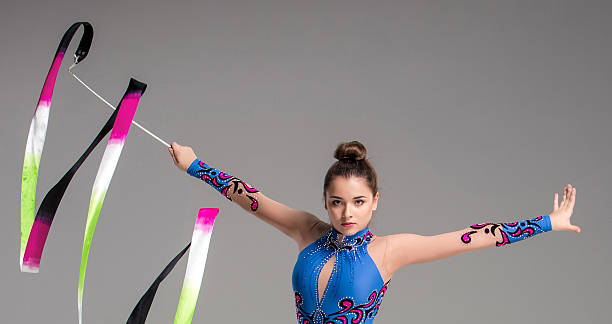 istock teenager doing gymnastics dance with ribbon 491564448
