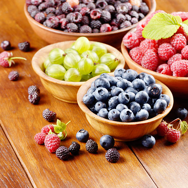 istock Wooden bowls with organic berries 491574500