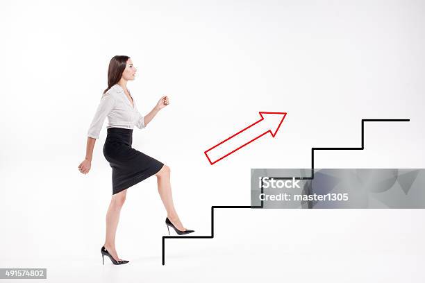 Young Businesswoman Walking Up On Stairs Stock Photo - Download Image Now - Climbing, Staircase, Steps