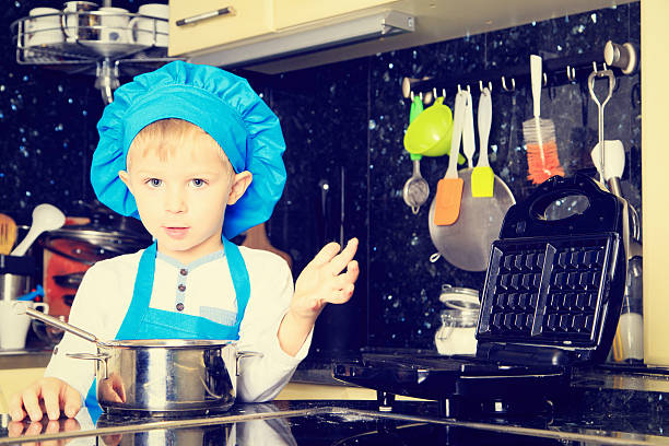 istock little boy enjoy cooking in kitchen 491575444