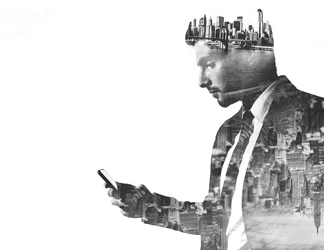 Businessman with phone double exposed with city images