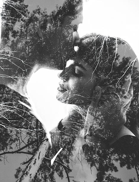 Loving couple image with tree branches in photgraphic effect Double exposure image of a monochrome picture of a loving couple image with tree branches overlaid in a photgraphic effect forehead photos stock pictures, royalty-free photos & images