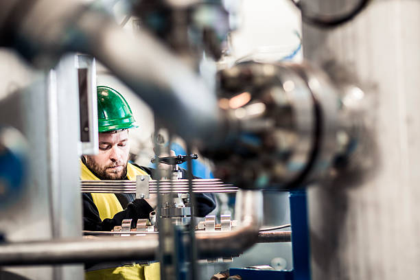 istock Serious manufacturing professional working at factory 491576232