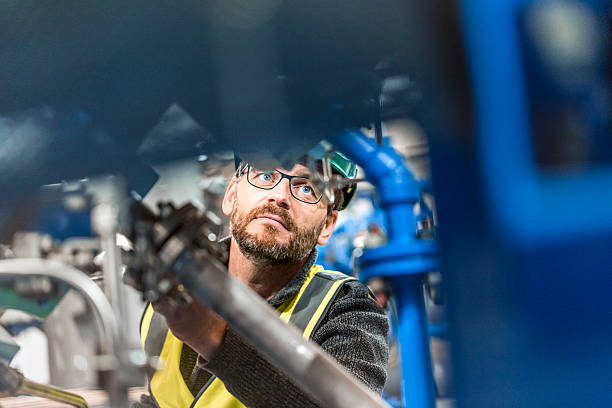 istock Male professional examining machine at factory 491577084
