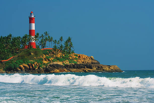 istock Lighthouse on the rocks near the ocean. 491577584