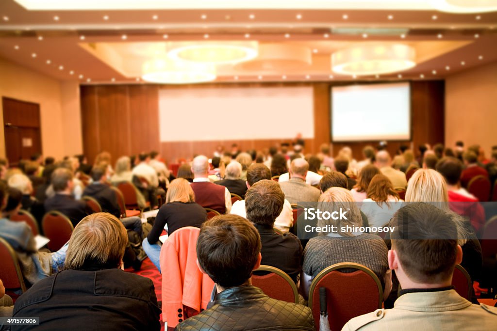 Report Rear view of many listeners sitting on chairs during lecture at conference Conference - Event Stock Photo