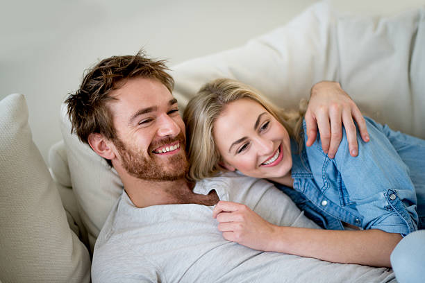 istock Loving couple relaxing at home watching tv 491578810