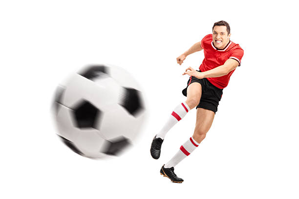 istock Young football player kicking a ball hard 491578866