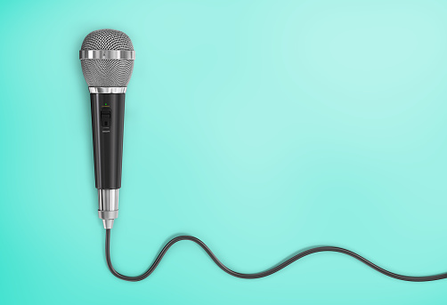 Concept of analog signal. Microphone with cord in the form of analog wave on a blue background.