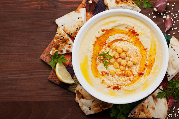Hummus or houmous, mashed chickpeas with tahini, text copy space stock photo