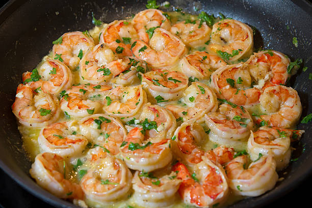 shrimp scampi sautéed in butter and garlic stock photo