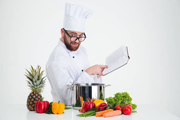 istock Male chef cook in glasses holding receipe book 491581922