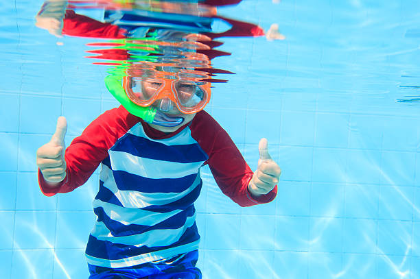 istock cute little boy swimming underwater 491582022
