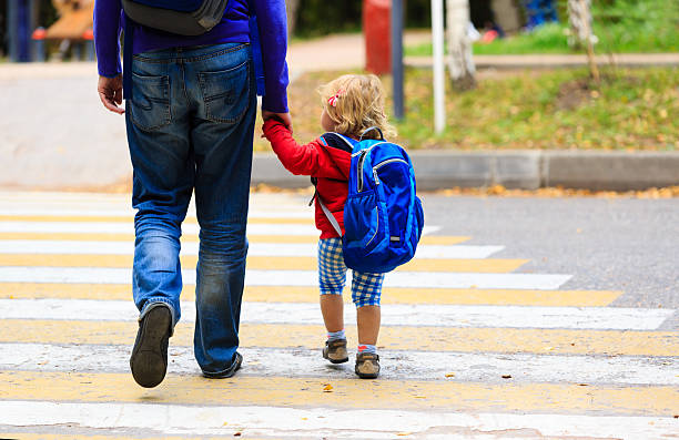 father with little daughter walking to school or daycare father walking little daughter with backpack to school or daycare kid holding fathers hand stock pictures, royalty-free photos & images