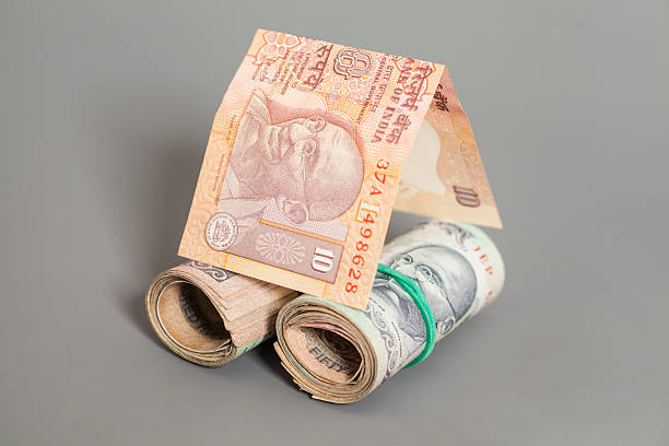 istock House Made Roll of Indian rupee banknotes isolated on gray 491600728