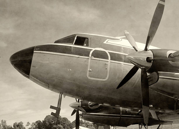 Retro propeller airplane nose view in stained black and white photo
