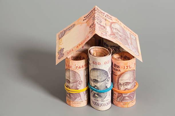 istock House Made Roll of Indian rupee banknotes isolated on gray 491600850