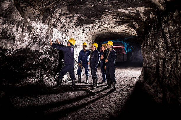 gruppo di uomini che lavorano in una miniera - picking up safety working men foto e immagini stock