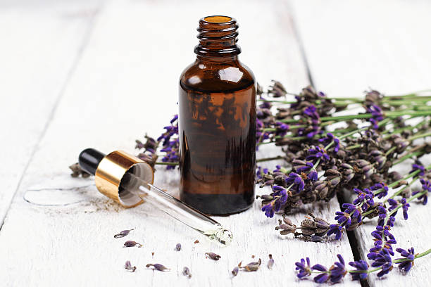Dry lavender and oil  on a white wooden table stock photo