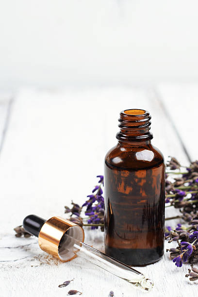 istock Dry lavender and oil  on a white wooden table 491601052
