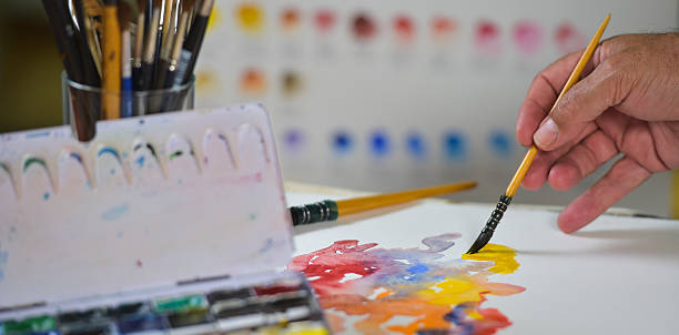 istock Artist's hand applying paint gouache on the drawing sheet 491602784