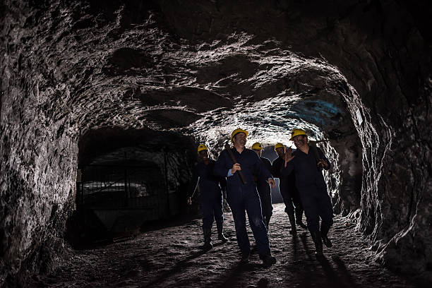 istock Group of miners walking in a dark tunnel 491602876