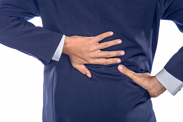 istock Backache concept bending over in pain with hands holding 491603152