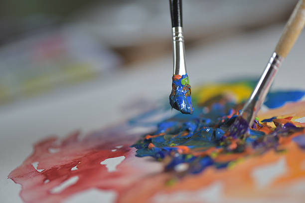istock Artist's hand applying paint gouache on the drawing sheet 491603504